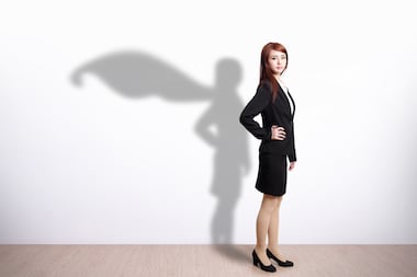office worker standing by wall and shadow in the wall has a cape like a superhero