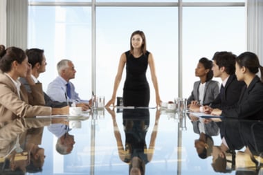 woman standing at boardroom table