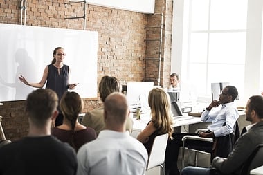 workers in a training meeting being shown a presentation