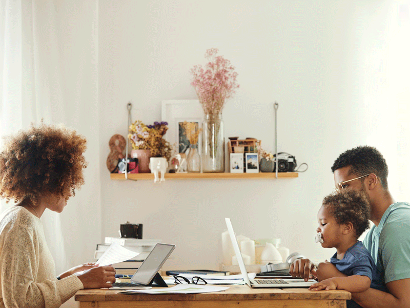 Adults sitting at table working flexibly with small child