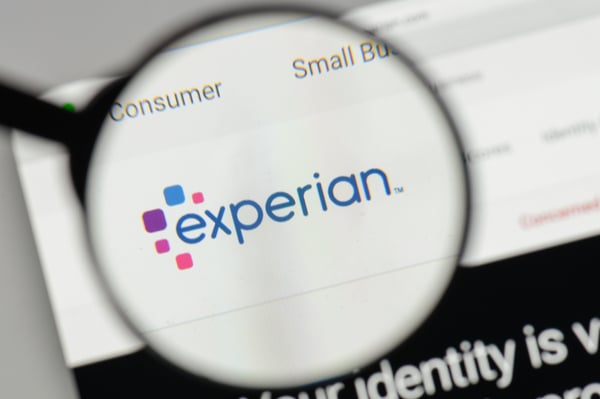 Experian logo through a magnifying glass