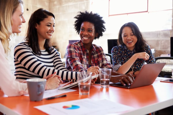 group of women looking at a laptop