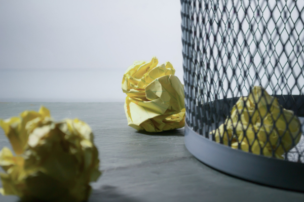 Scrunched up paper near a bin