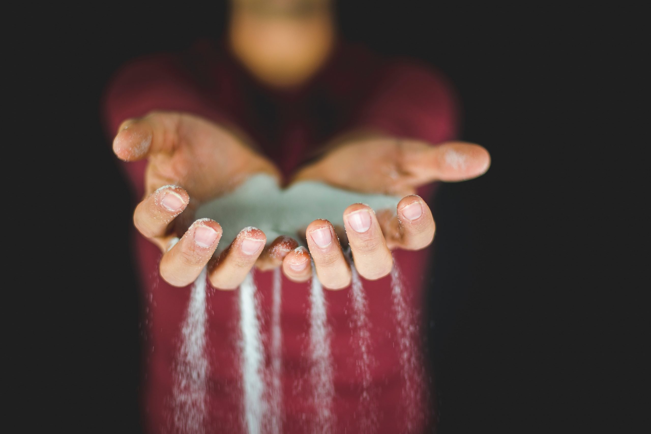 Sand falling through someones hands