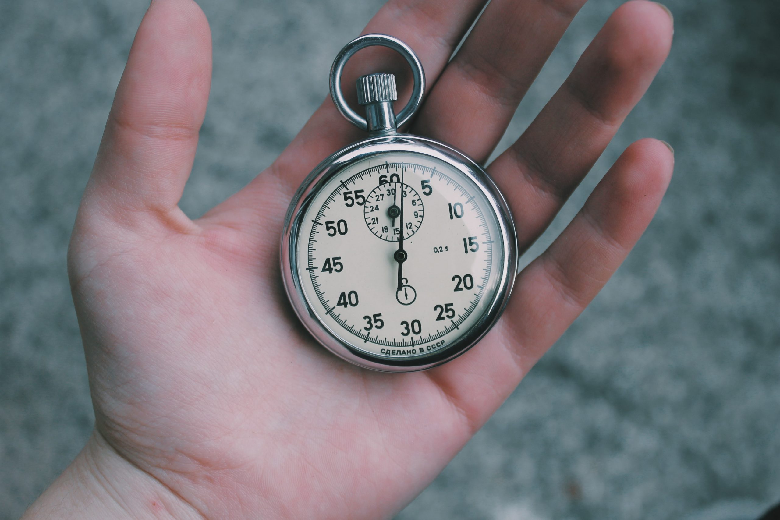 A pocket watch in the palm of someone's hand