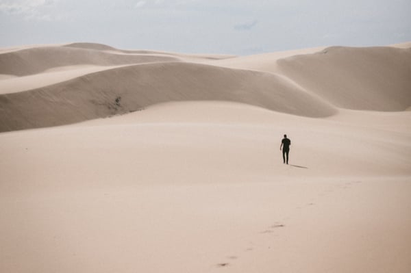 person walking in the desert