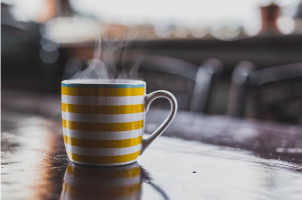 white and yellow striped mug on a table