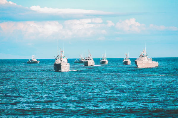 a group of royal navy ships in the ocean