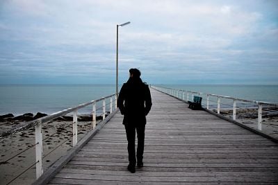 person walking on wooden pier
