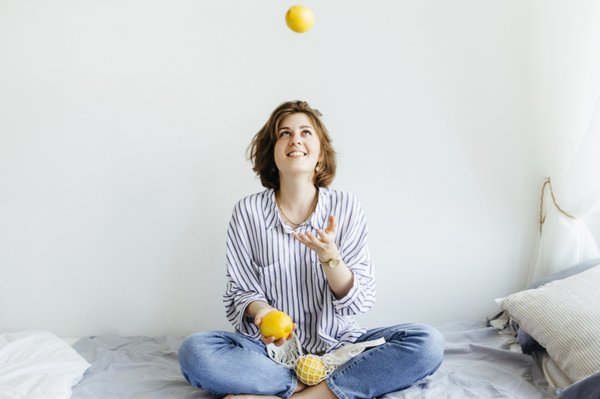 a woman sitting down juggling