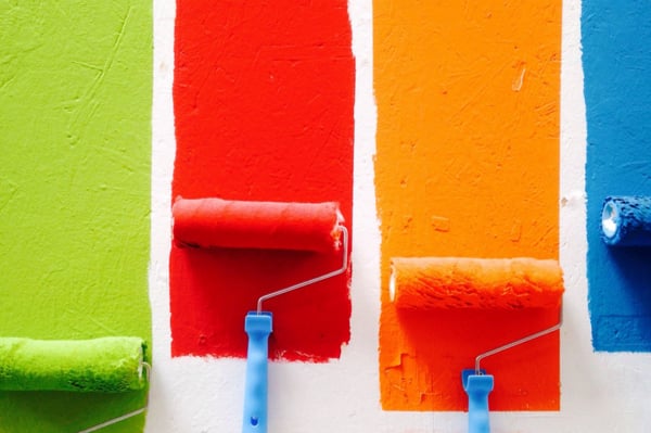 Green, red, orange and blue paint brushes