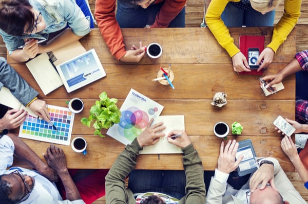 people sitting around the table and working together