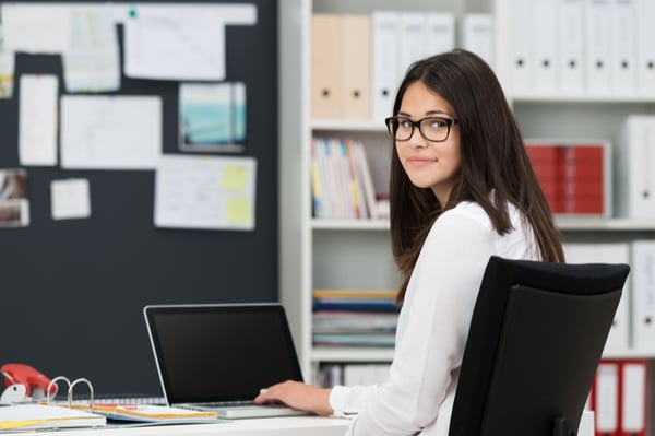 Woman sitting at her desk on her laptop