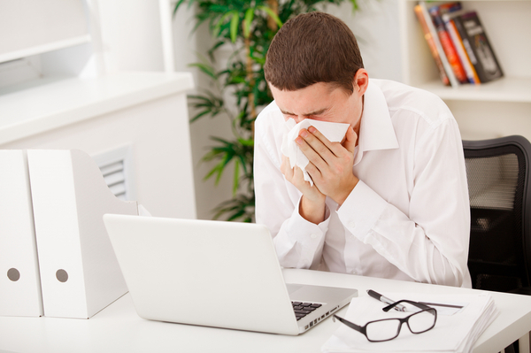 man being sick at work