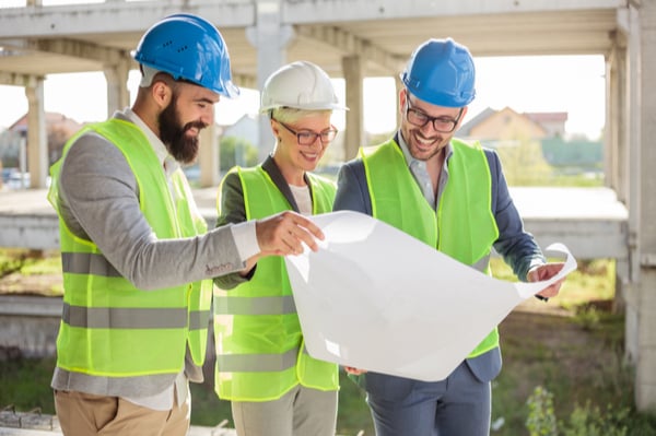 People looking at building plan