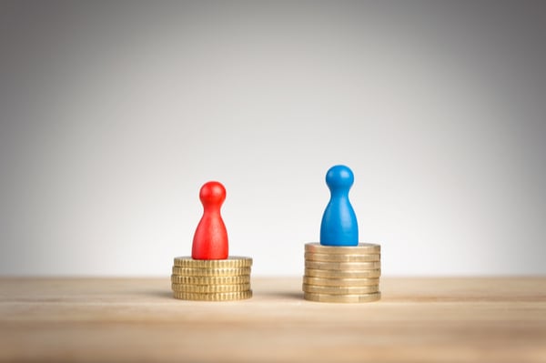 Two board game pieces on piles of coins