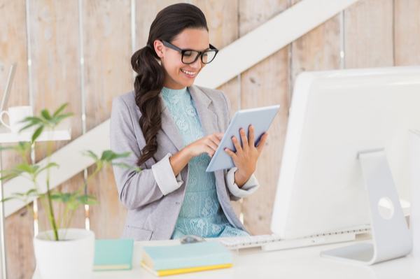 Woman looking at tablet and smiling