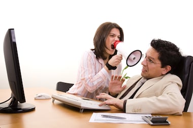 Women shouting at man with microphone