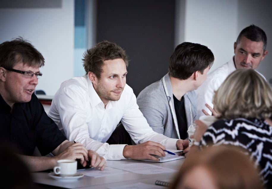 Group of colleagues sitting around a table having a meeting