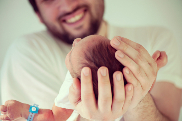 Dad holding his baby with two hands