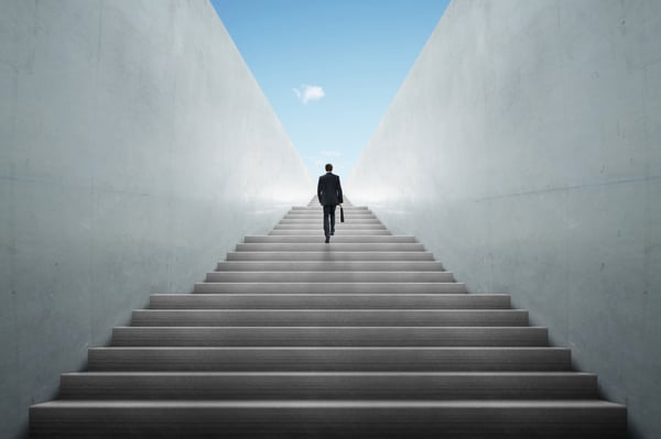 man in suit walking up stairs