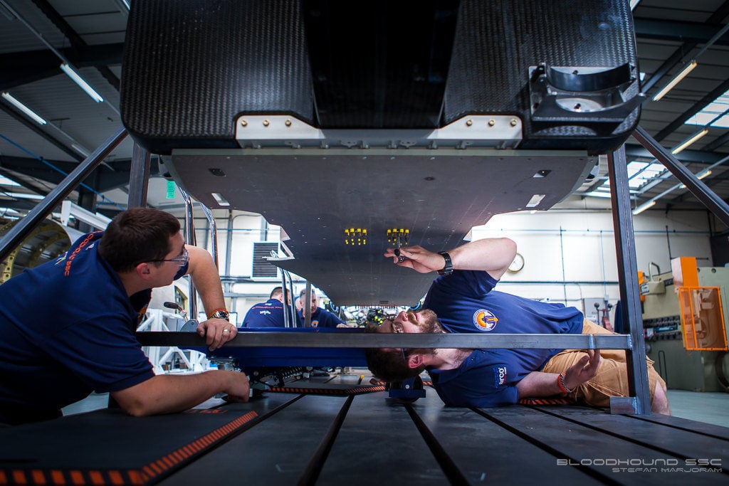 SSCB1 mechanics working on the underside of a car
