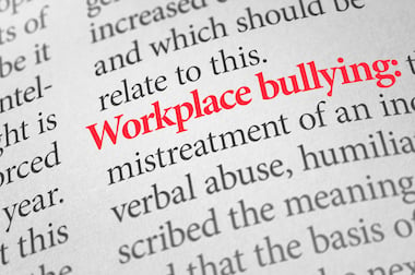 Dictionary with the word workplace bullying highlighted in red
