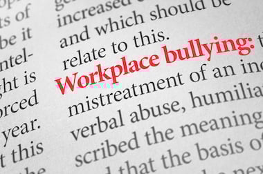 Dictionary with the word workplace bullying highlighted in red