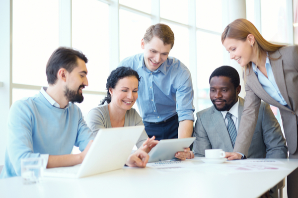 group of people around laptops