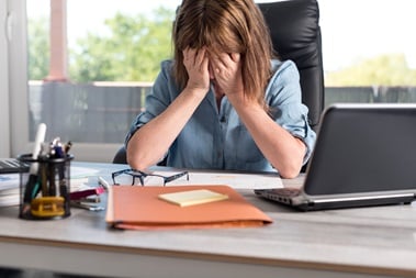 Overworked women with head in her hands