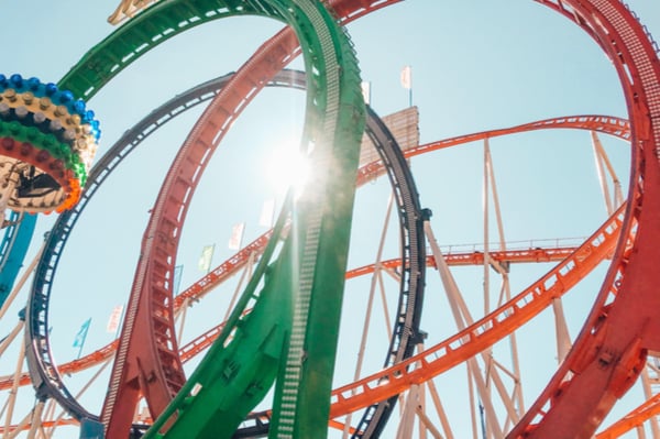 a rollercoaster with three loops - one is green, one is red, one is blue