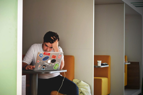 A young man in front of a laptop