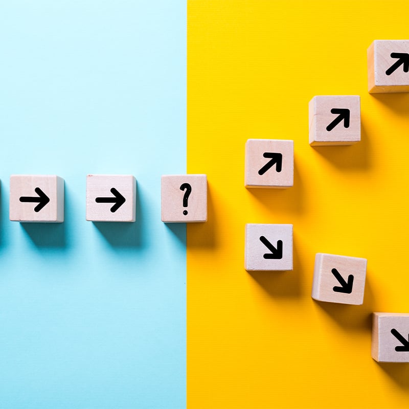 wooden blocks with arrows on showing steps in direction and choices