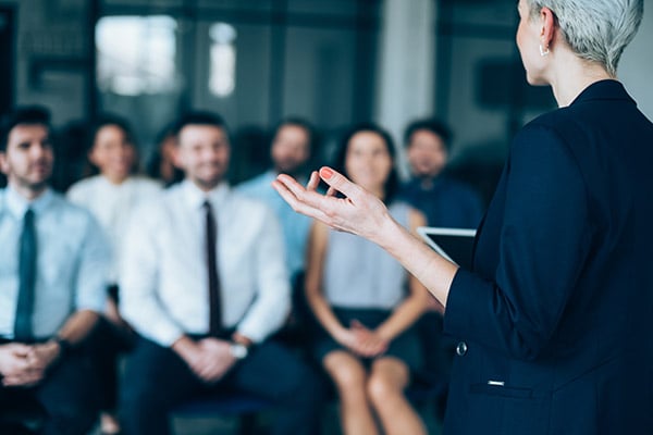 Manager talking to a group of office staff