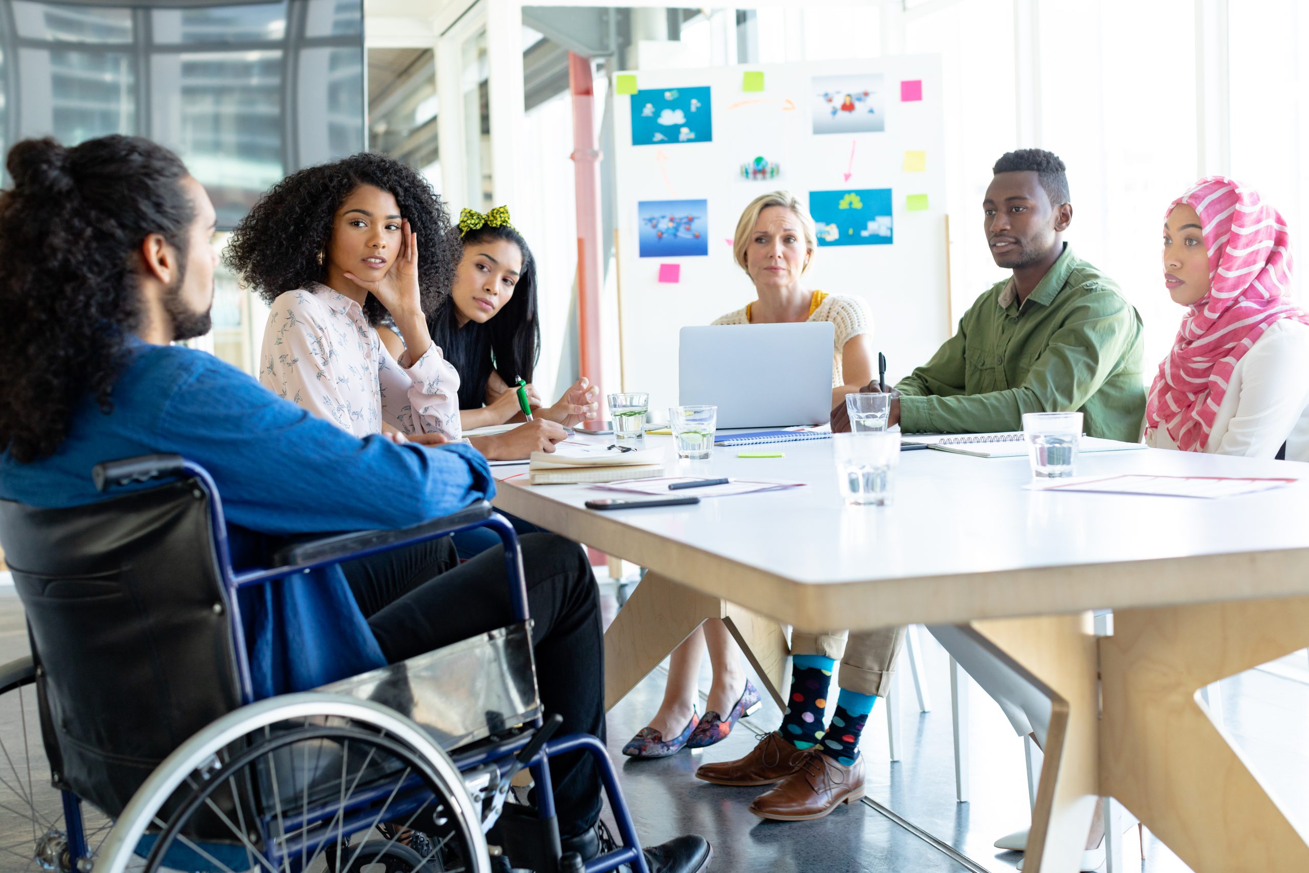 Front view of diverse business people discussing with each other in meeting at conference room in a modern office