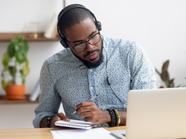 Person working in the new normal: laptop open and headphones on