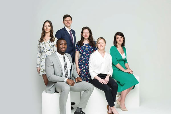 male and female apprentices sitting down for photo