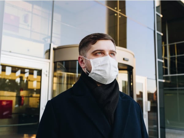 Person in face mask outside of workplace