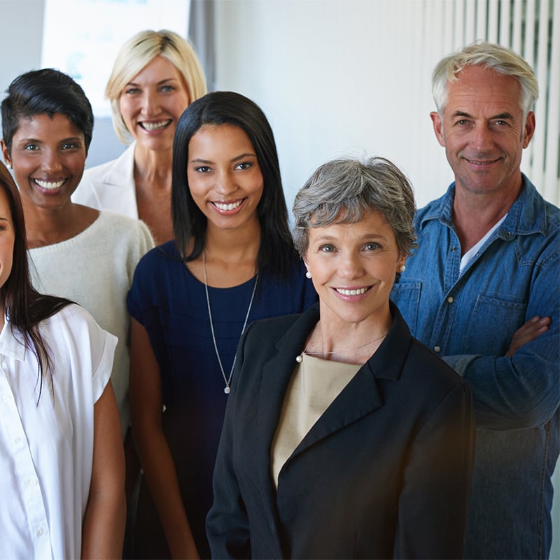 male and female office workers posing for photo