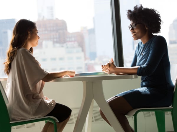 Two women having a conversation at work