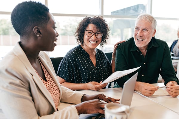 diverse workers at a table having discussions