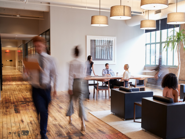 Blurred employees walking through office