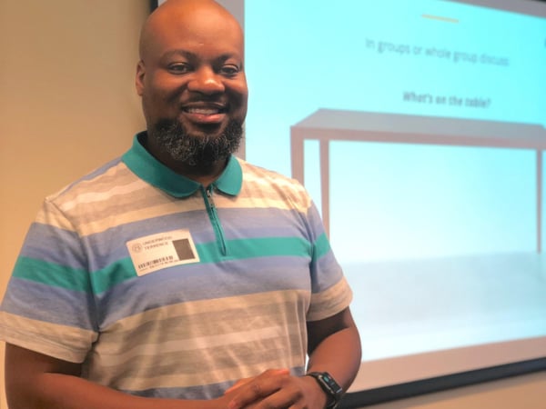 Teacher standing in front of presentation