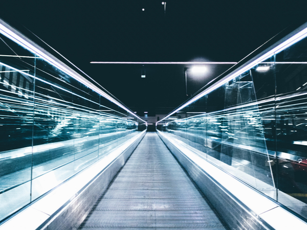 long-exposure image of bright lights over escalator