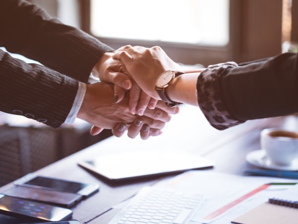 People shaking hands at work as a sign of trust