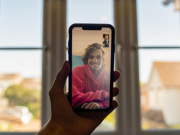 Person on a phone screen's video call