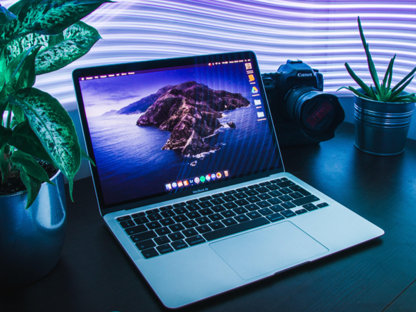 Laptop against a bright purple light