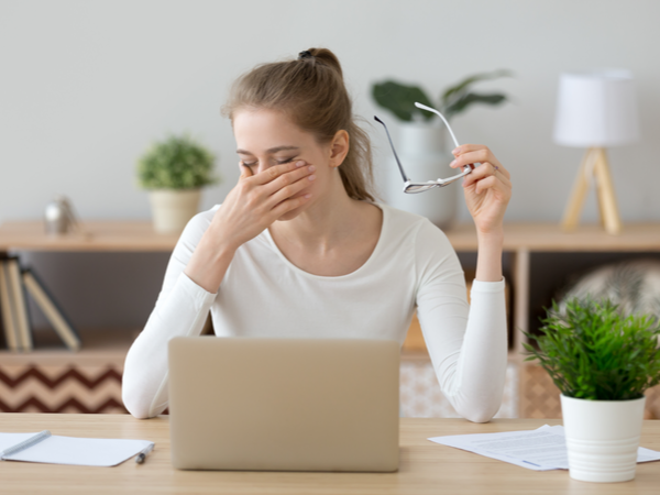 Woman rubbing her eyes in frustration