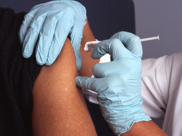Healthcare professional administering a vaccine jab
