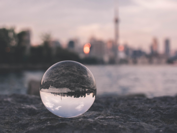 Glass ball in front of city skyline - the ball has inverted the skyline so it's upside down